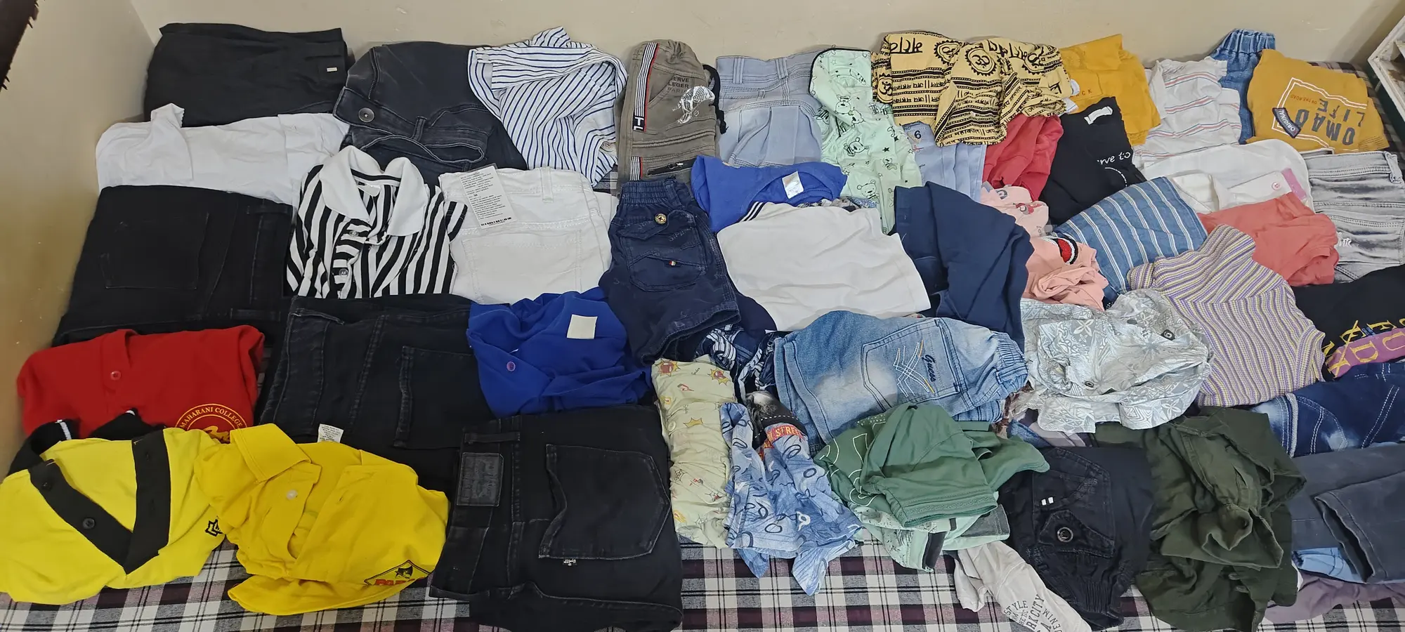 Clothing sorted and arranged before a foundation community-support activity in Jaipur.