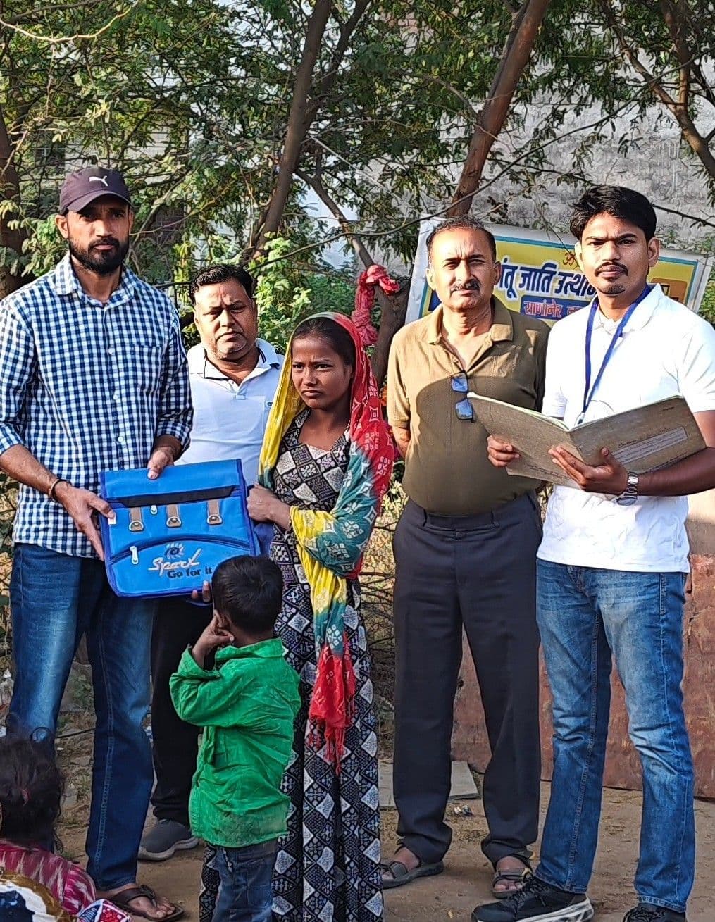 Foundation members and children during a school material distribution drive.