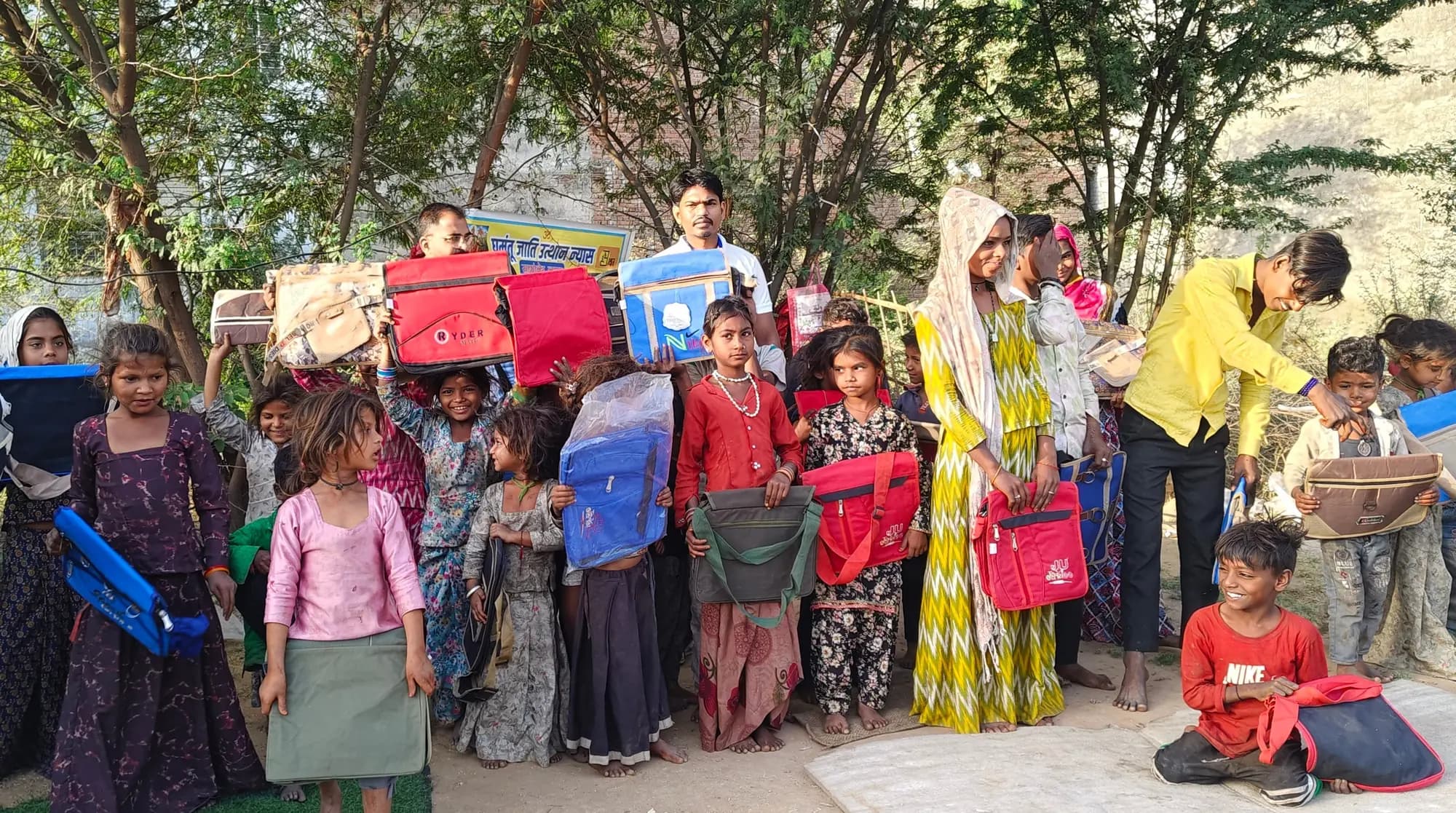 Children and foundation volunteers together during an April school-bag and learning-material activity.