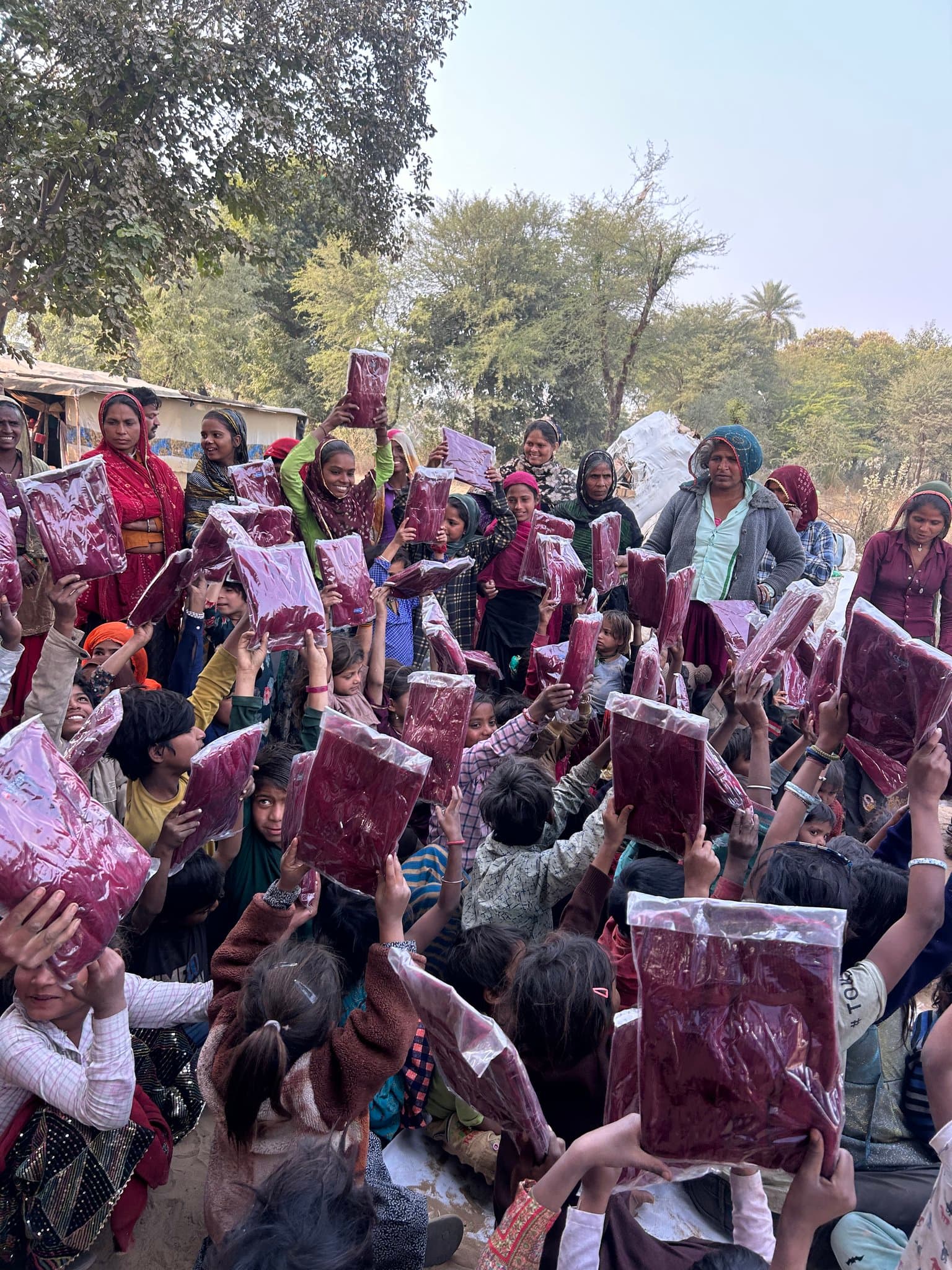 Children and community members gathered during winter support distribution.